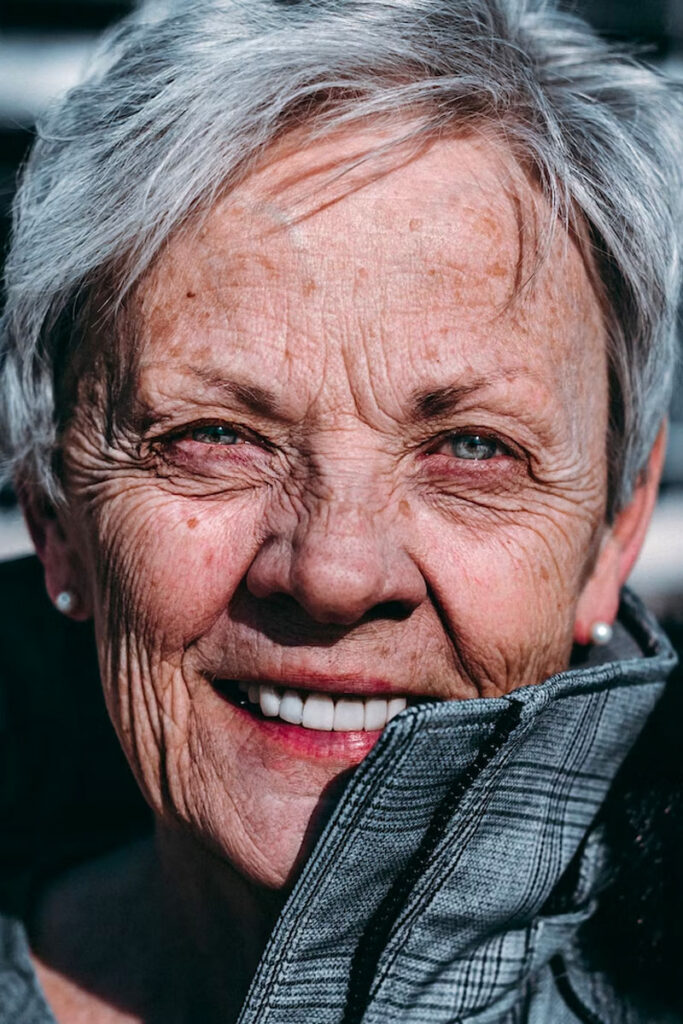 smiling older woman with dental crowns